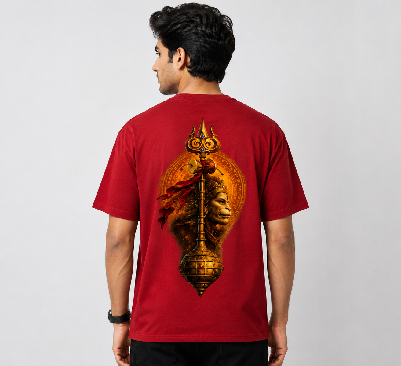 Person wearing a red t-shirt with a lion and temple design on the back against a white background