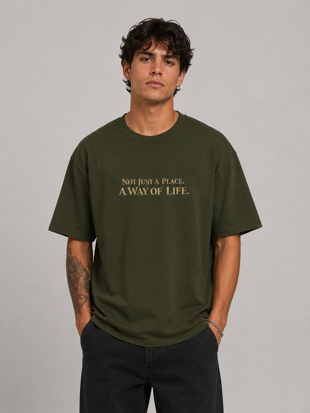 Person wearing a green t-shirt with text on a gray background