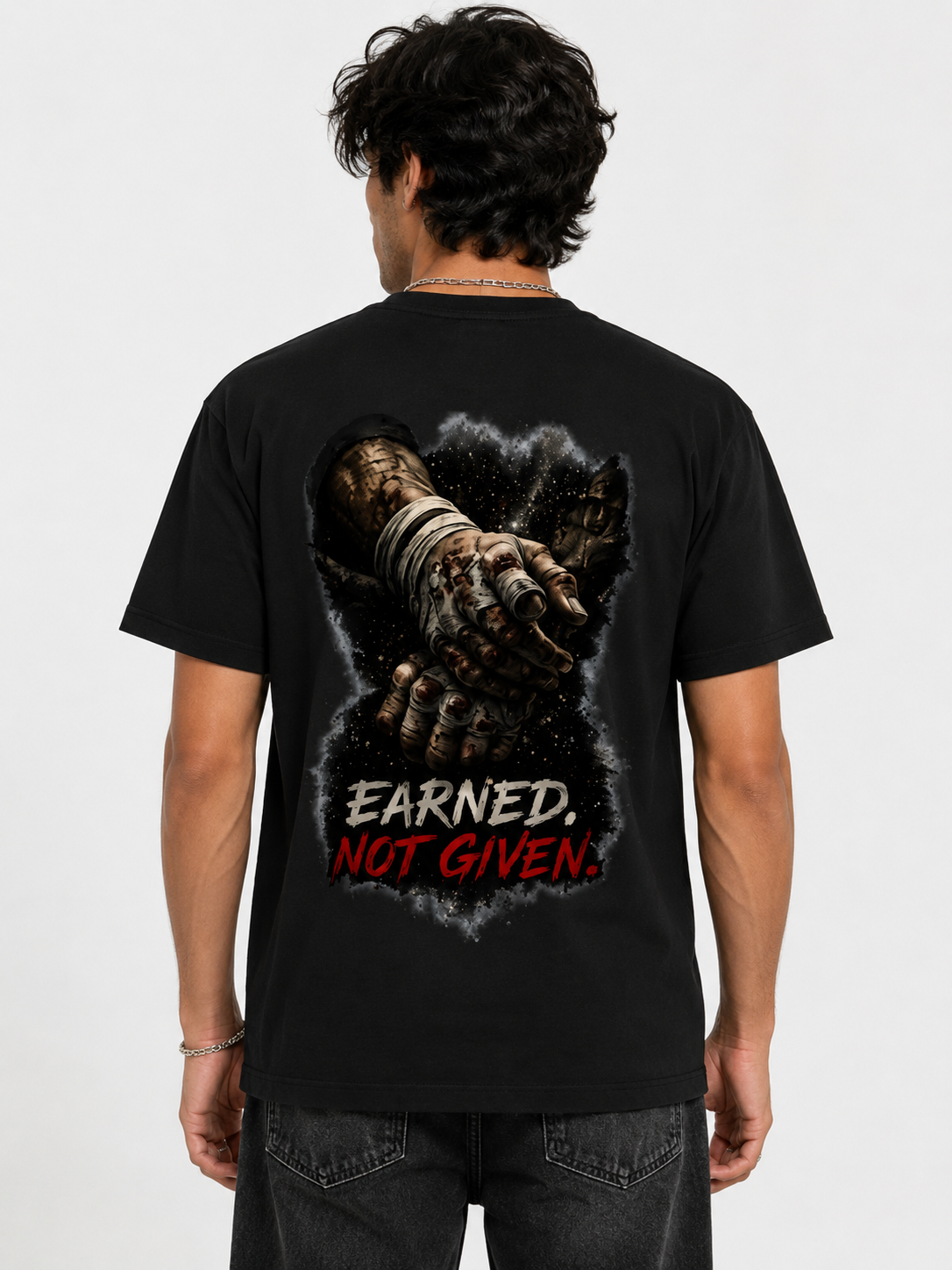 Person wearing a black t-shirt with a graphic design and text on the back.