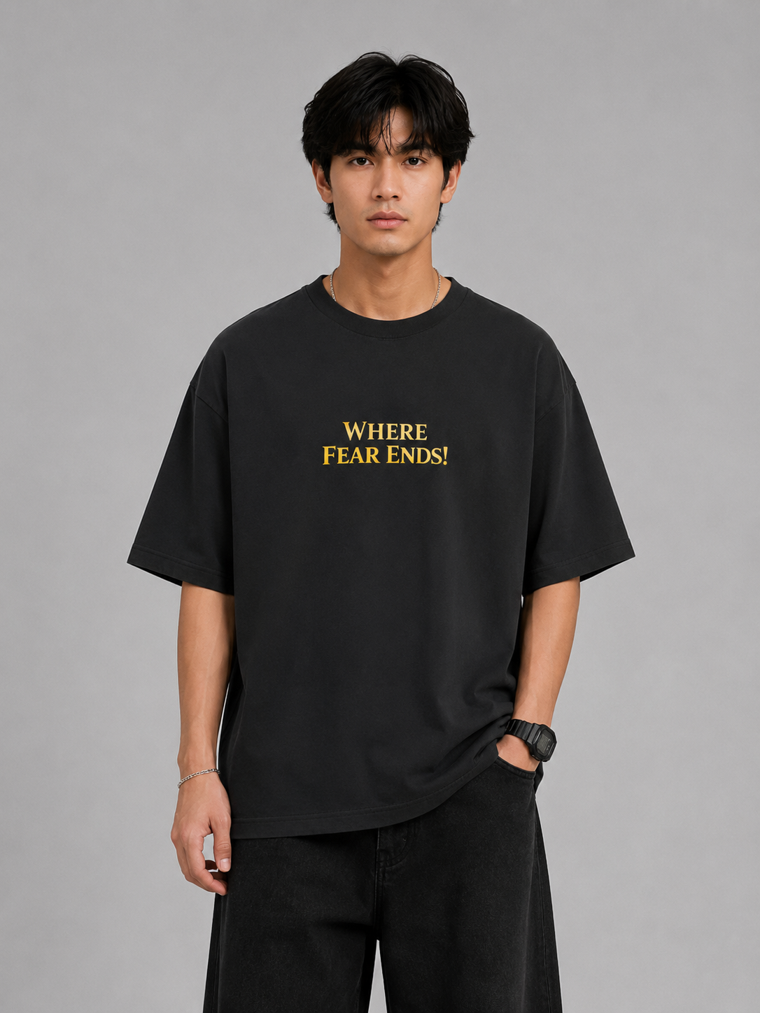Person wearing a black t-shirt with 'WHERE FEAR ENDS!' text on a gray background