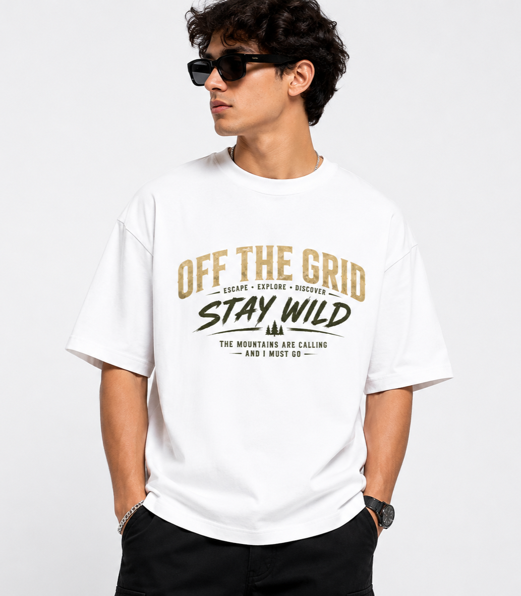 Man wearing a white t-shirt with 'Off The Grid Stay Wild' text design on a plain background