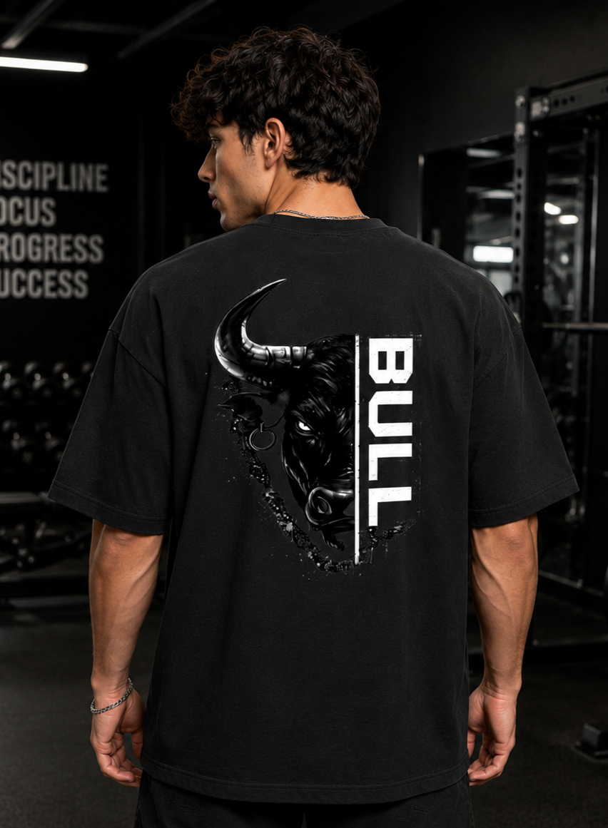 Person wearing a black t-shirt with a bull graphic and 'BULL' text on the back in a gym setting.