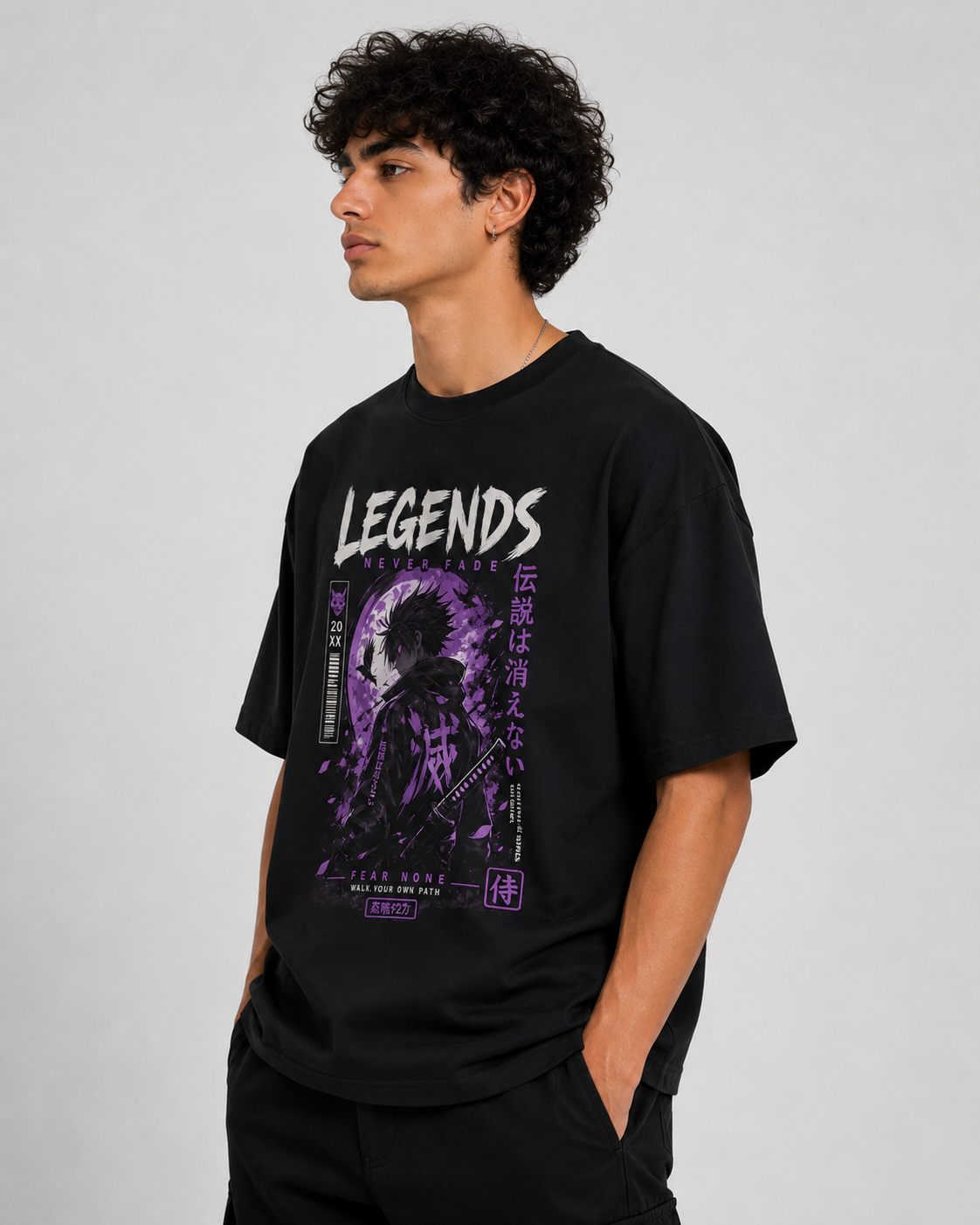 Left-side view of a male model showcasing a black oversized anime graphic t-shirt with bold manga-inspired artwork and relaxed fit.