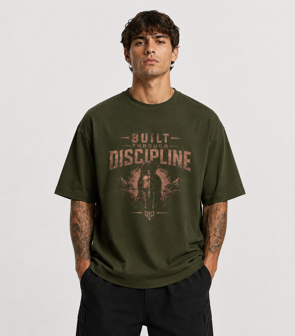 Man wearing a green t-shirt with motivational text on a plain background
