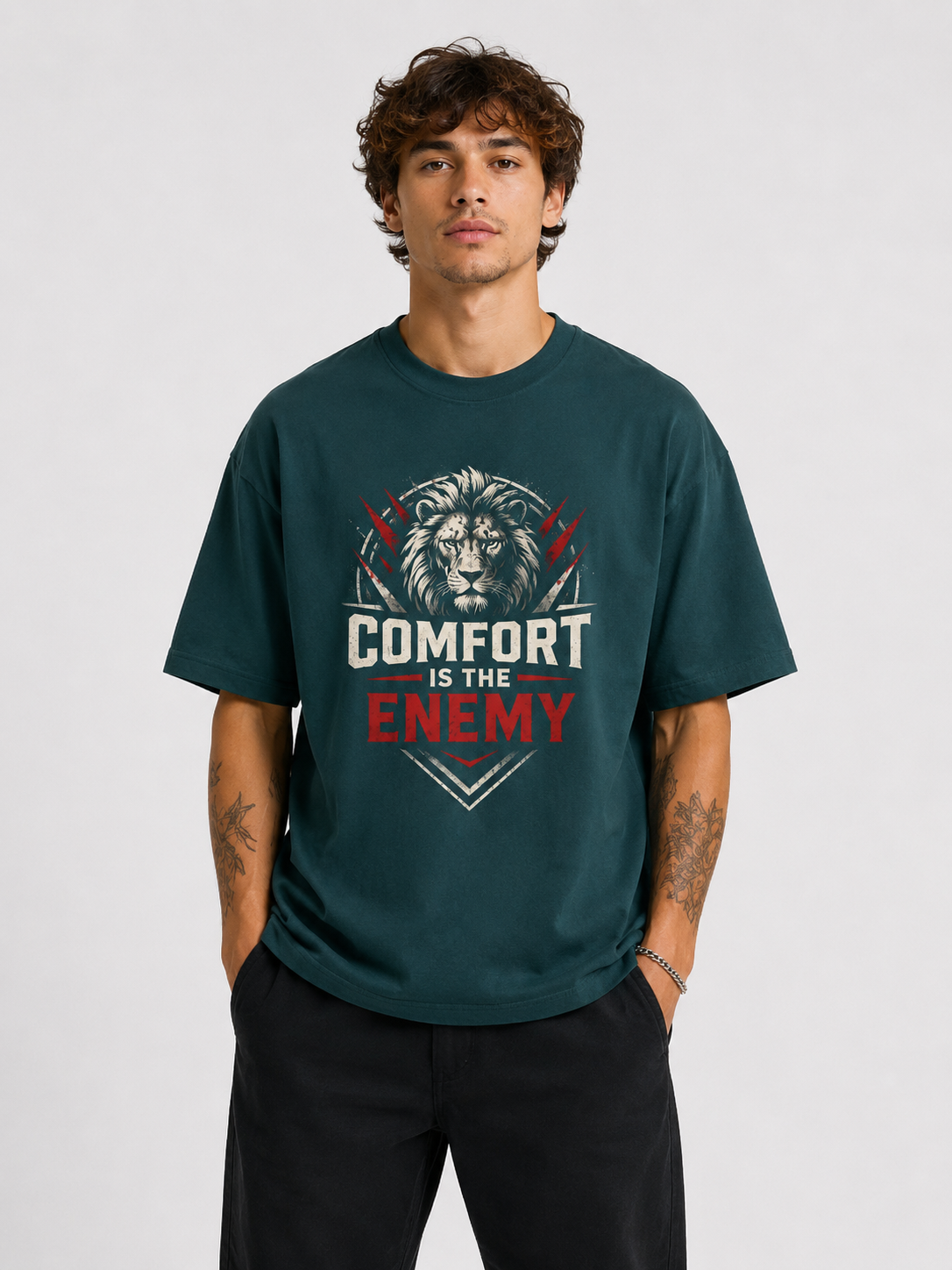 Person wearing a green t-shirt with a lion graphic and text on a plain background