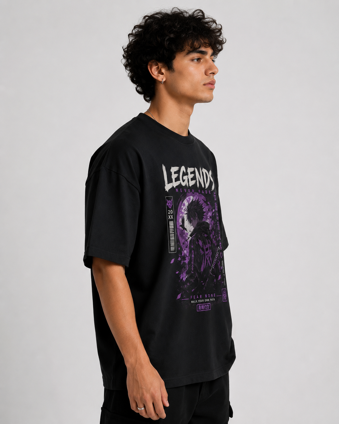 Person wearing a black t-shirt with a graphic design and text on a plain background