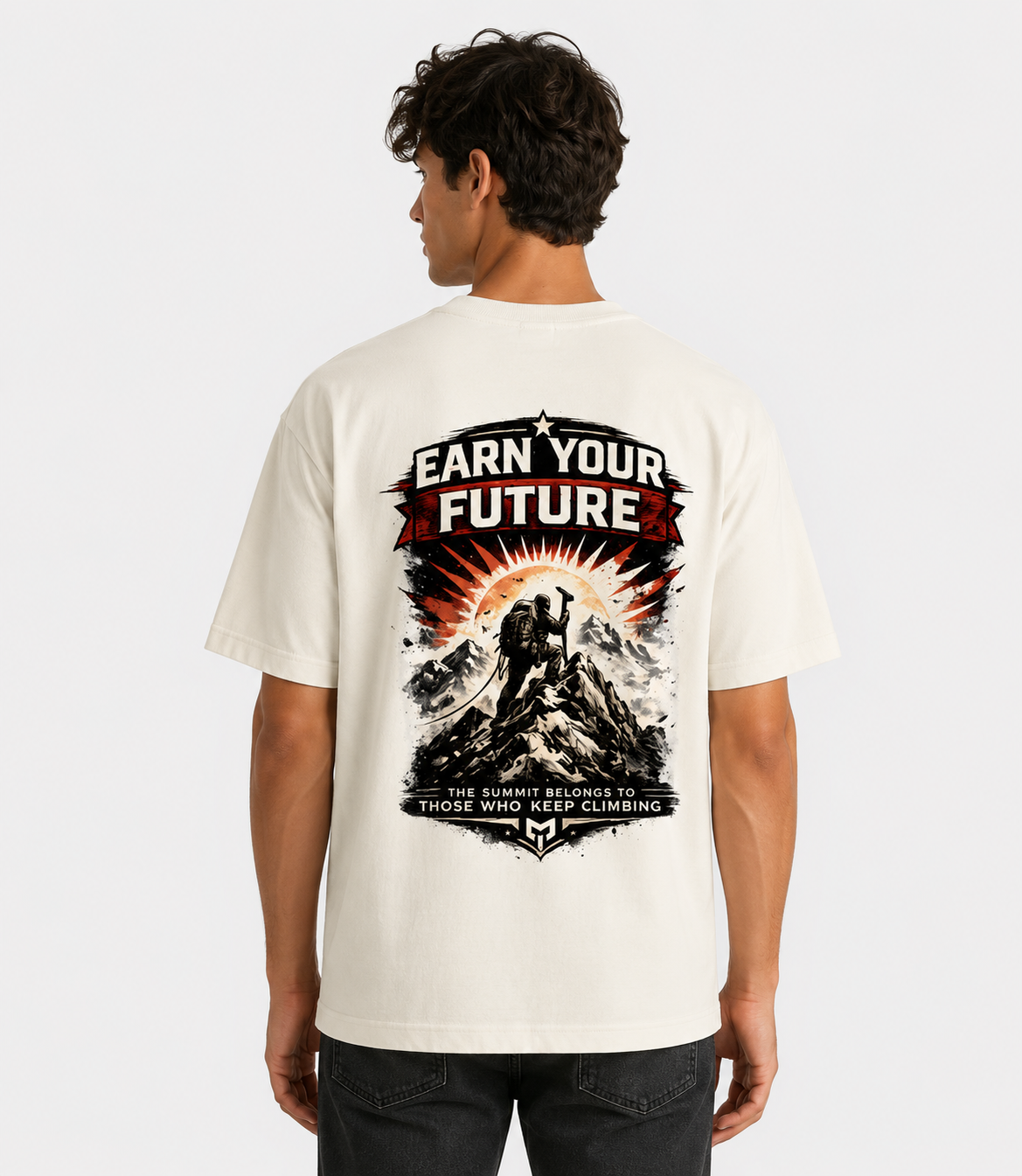 Person wearing a white t-shirt with a mountain graphic and text on the back